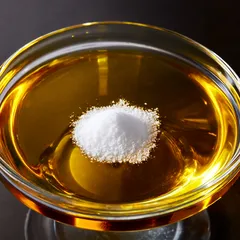 Ciotola di olio con cucchiaio di sale al centro su sfondo scuro